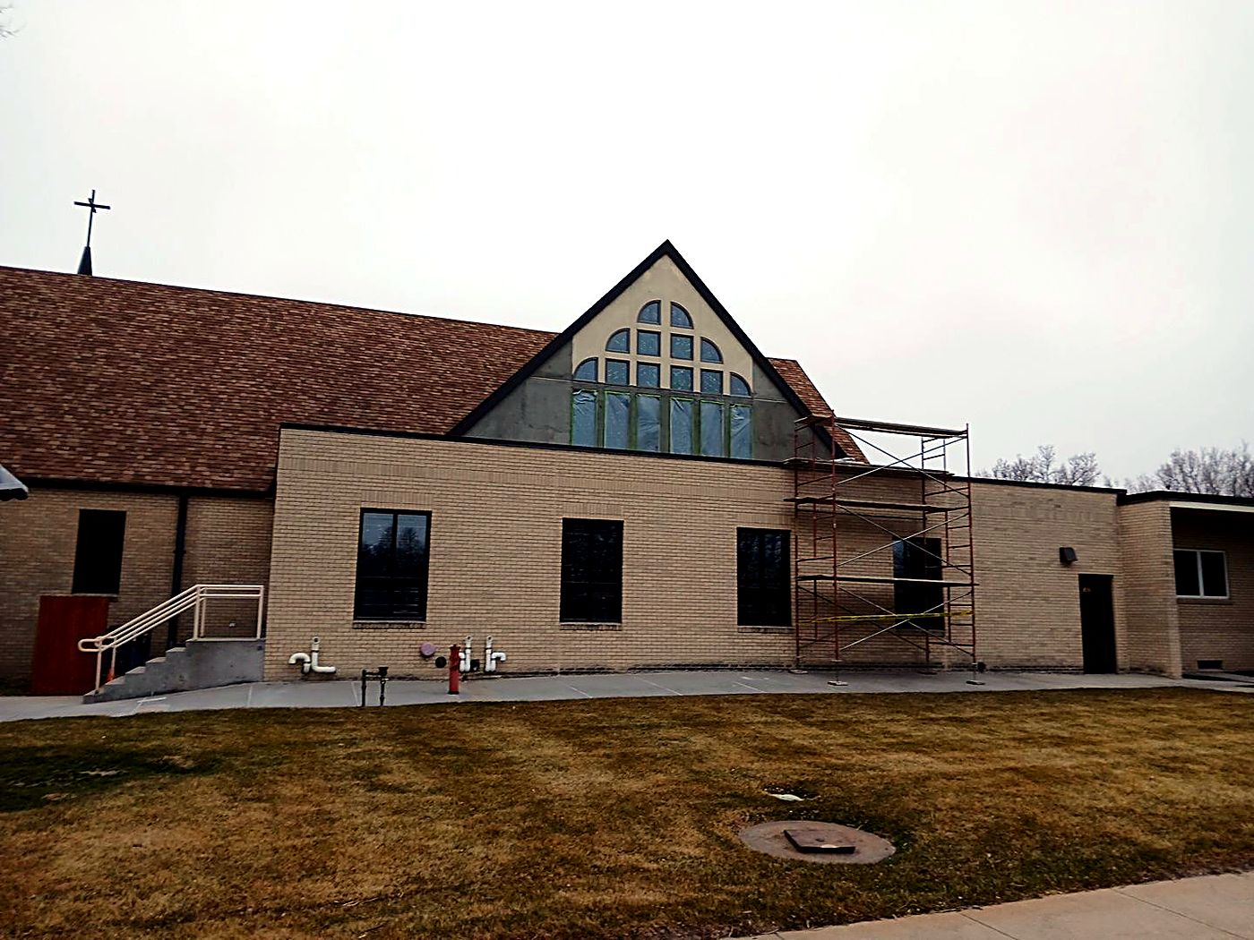 The A-frame window wall of Christ The King Catholic Church in Gering during exterior restoration