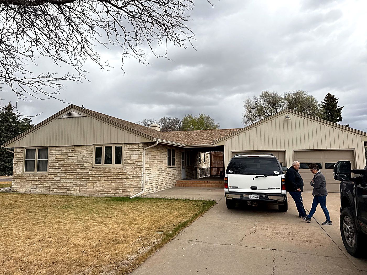 Schank Roofing meeting a homeowner in the driveway at the start of a roof inspection in Kimball