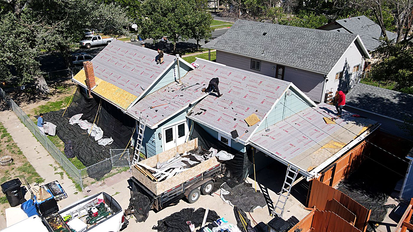 Aerial view of a Schank Roofing crew replacing a residential roof in Scottsbluff